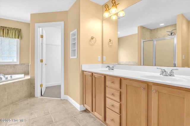 bathroom with a sink, double vanity, a shower stall, and a bath