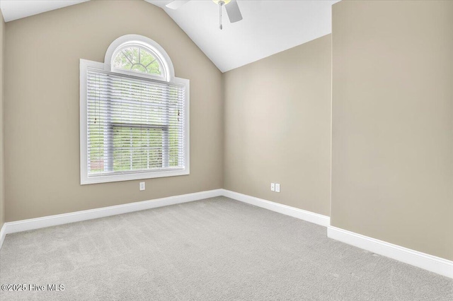 carpeted empty room with ceiling fan, lofted ceiling, and baseboards