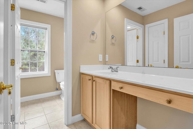 bathroom featuring toilet, vanity, visible vents, tile patterned flooring, and baseboards