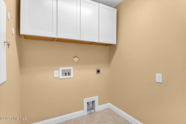 clothes washing area featuring cabinet space, gas dryer hookup, electric dryer hookup, washer hookup, and baseboards