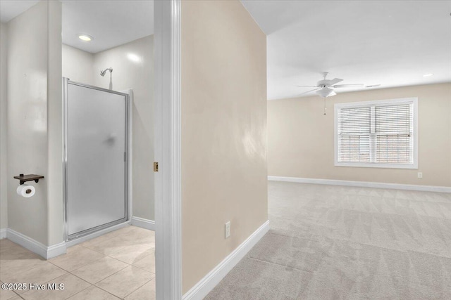 interior space featuring light colored carpet and baseboards