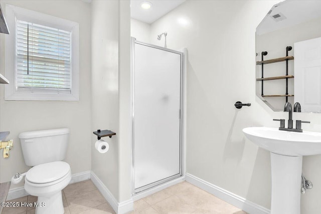 full bath with a shower stall, baseboards, tile patterned floors, and toilet