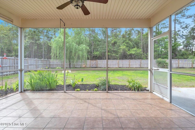 unfurnished sunroom with a ceiling fan