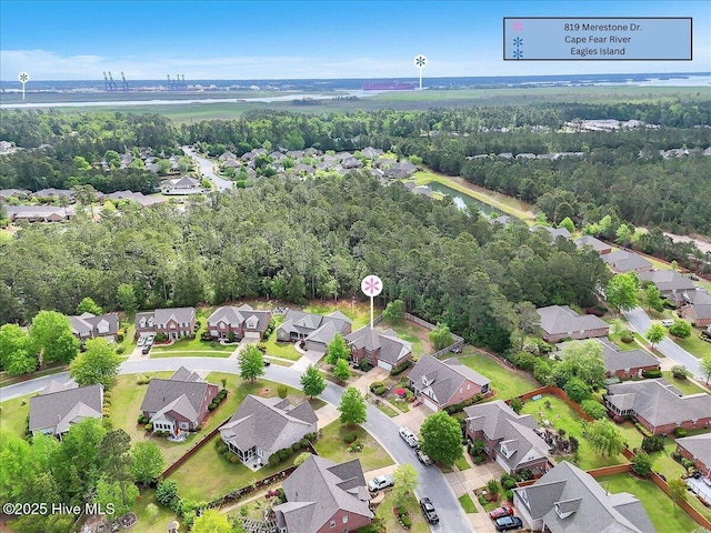 bird's eye view featuring a wooded view and a residential view