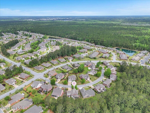 drone / aerial view with a residential view and a view of trees