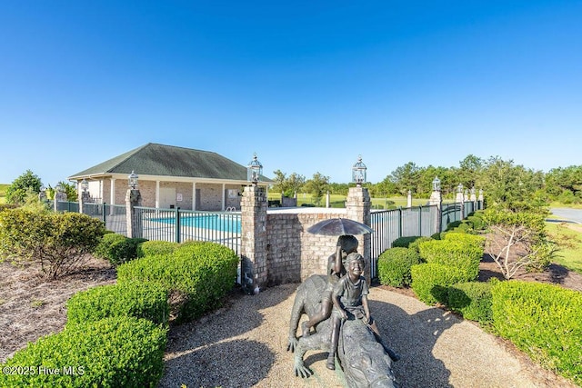 view of home's community with fence and a swimming pool