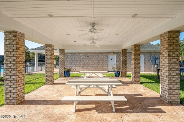 view of patio with fence and a ceiling fan