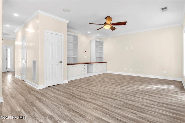 unfurnished living room featuring ceiling fan, ornamental molding, visible vents, and wood finished floors