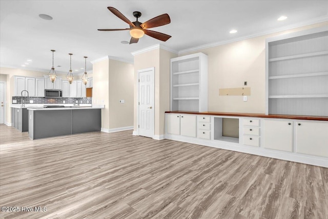 819 Merestone Dr, Leland, NC 28479 - unfurnished living room with light wood-style flooring, a ceiling fan, baseboards, ornamental molding, and recessed lighting