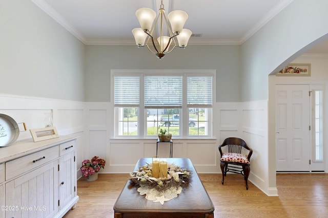429 Canvasback Ln, Sneads Ferry, NC 28460 - living area with arched walkways, a decorative wall, ornamental molding, light wood-style flooring, and wainscoting