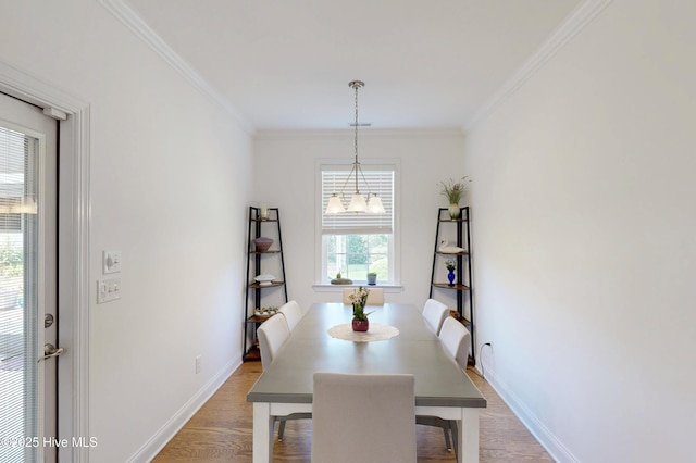 429 Canvasback Ln, Sneads Ferry, NC 28460 - dining space with light wood-style flooring, baseboards, ornamental molding, and a chandelier