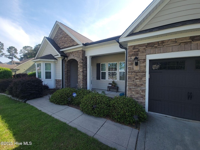 exterior space with stone siding and an attached garage