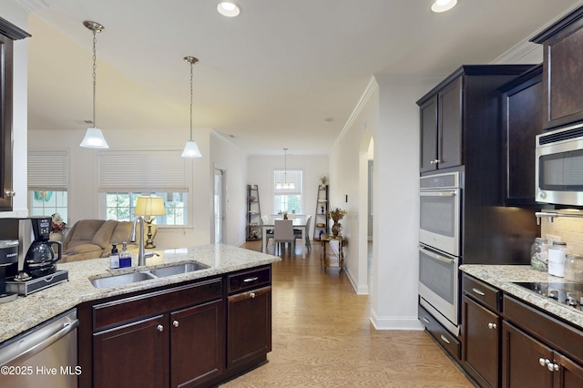 429 Canvasback Ln, Sneads Ferry, NC 28460 - kitchen featuring a sink, appliances with stainless steel finishes, light wood-type flooring, light stone countertops, and pendant lighting