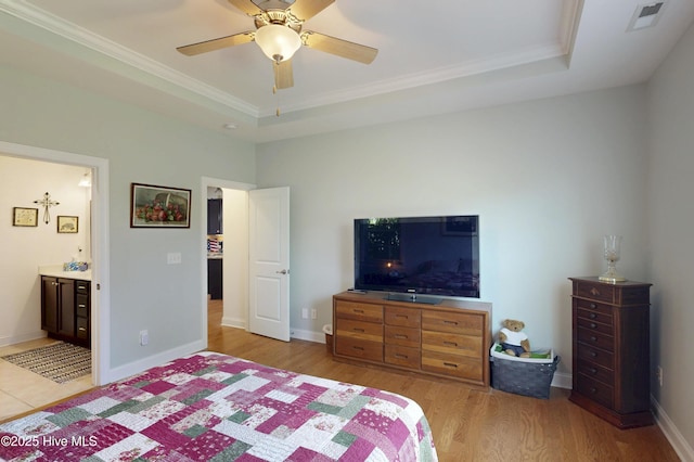 429 Canvasback Ln, Sneads Ferry, NC 28460 - bedroom featuring light wood-style floors, a raised ceiling, ornamental molding, connected bathroom, and baseboards