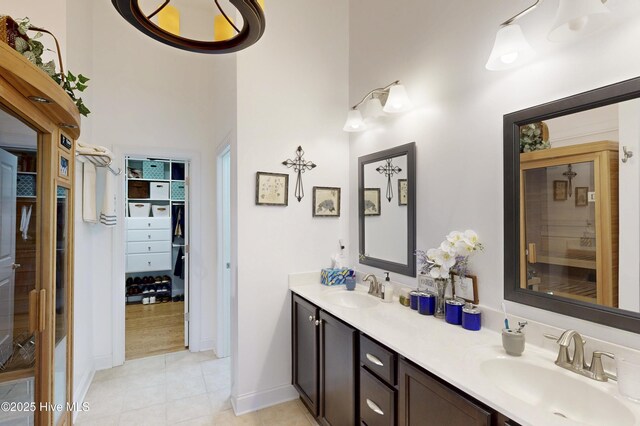 429 Canvasback Ln, Sneads Ferry, NC 28460 - bathroom featuring double vanity, tile patterned floors, a high ceiling, a spacious closet, and baseboards