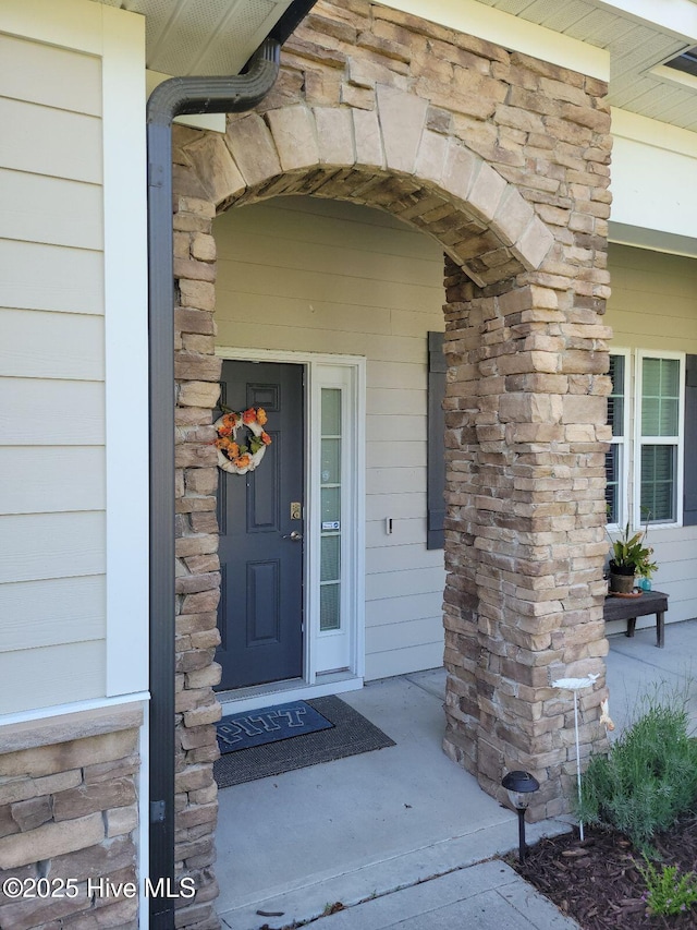 doorway to property with stone siding