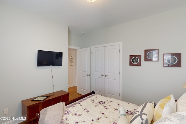 429 Canvasback Ln, Sneads Ferry, NC 28460 - bedroom featuring wood finished floors, a closet, and baseboards