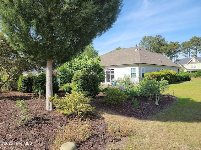 view of property exterior with a lawn