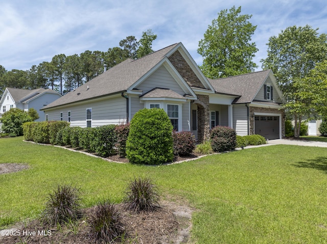 429 Canvasback Ln, Sneads Ferry, NC 28460 - craftsman-style home with roof with shingles, stone siding, a front yard, and concrete driveway