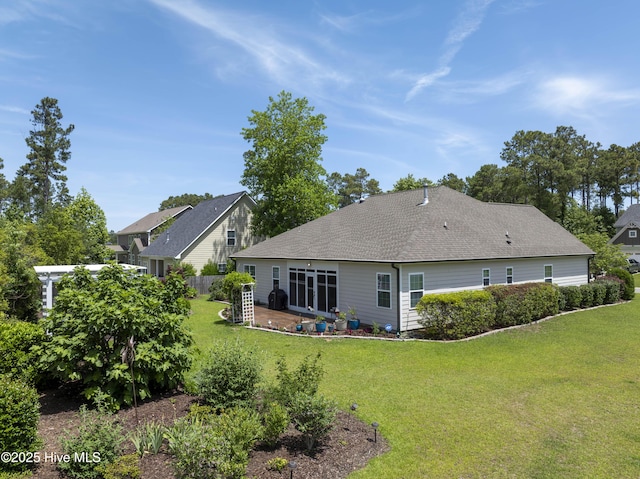 429 Canvasback Ln, Sneads Ferry, NC 28460 - back of house with a lawn and a shingled roof