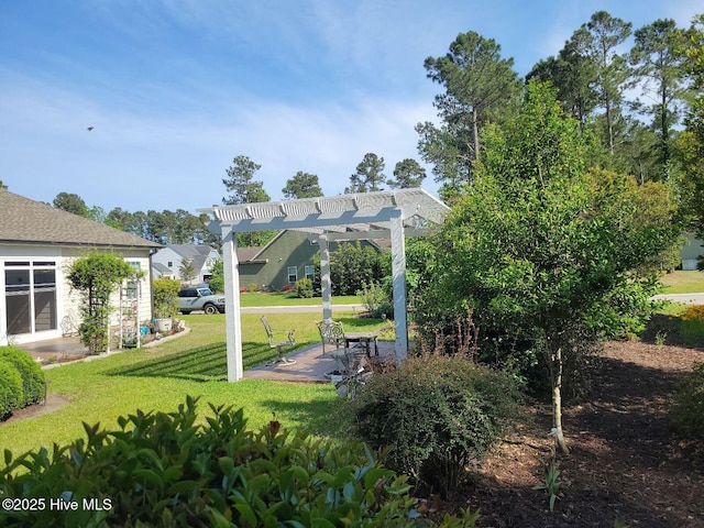 view of property's community featuring a pergola, a patio area, and a lawn