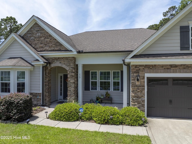 429 Canvasback Ln, Sneads Ferry, NC 28460 - craftsman inspired home featuring stone siding, roof with shingles, and driveway