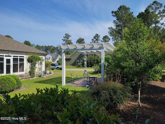 view of property's community with a pergola and a lawn