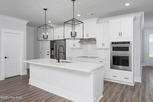 735 Hollybriar Loop Rd SE, Bolivia, NC 28422 - kitchen featuring stainless steel appliances, a sink, a chandelier, dark wood-type flooring, and a kitchen island with sink