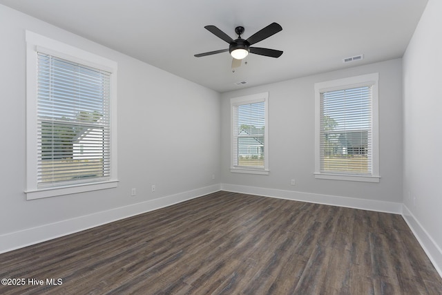 735 Hollybriar Loop Rd SE, Bolivia, NC 28422 - spare room featuring dark wood-style flooring, baseboards, and a ceiling fan