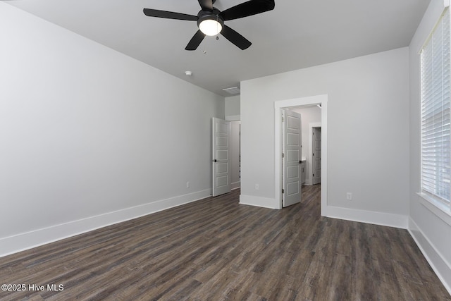 735 Hollybriar Loop Rd SE, Bolivia, NC 28422 - unfurnished bedroom featuring dark wood finished floors, baseboards, and ceiling fan