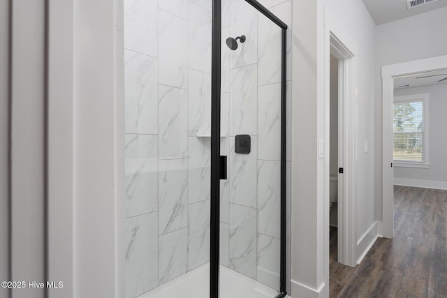 735 Hollybriar Loop Rd SE, Bolivia, NC 28422 - full bath featuring a marble finish shower, wood finished floors, toilet, and baseboards