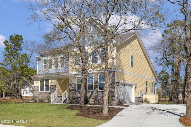 735 Hollybriar Loop Rd SE, Bolivia, NC 28422 - view of front of home featuring stone siding, concrete driveway, a garage, and a front yard