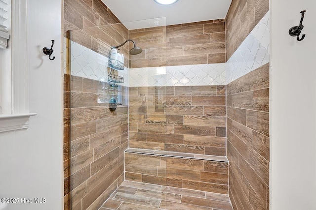 full bath featuring tiled shower