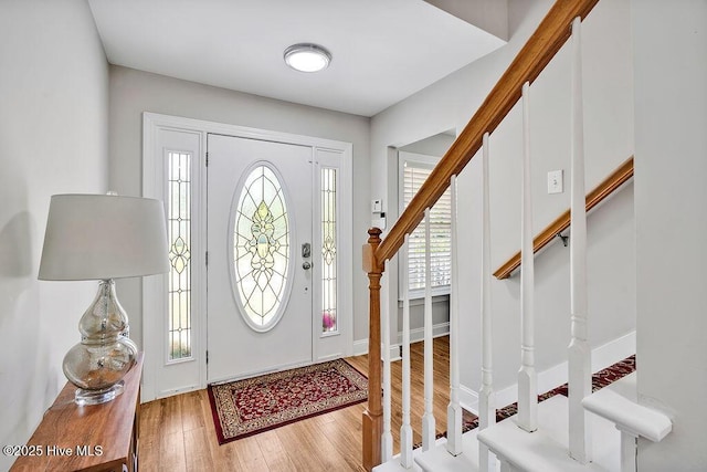 entryway featuring stairs and wood finished floors