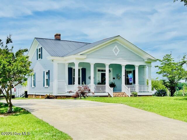 45 Hb Lewis Rd, Clinton, NC 28328 - view of front of house featuring a chimney, covered porch, a front lawn, concrete driveway, and metal roof