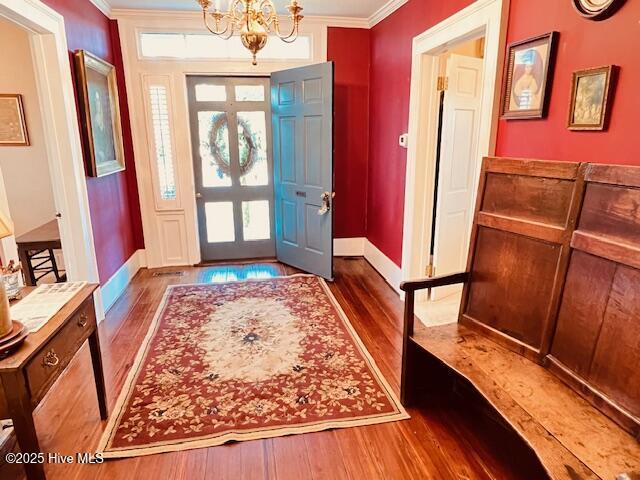 45 Hb Lewis Rd, Clinton, NC 28328 - foyer entrance featuring wood finished floors, ornamental molding, a chandelier, and baseboards