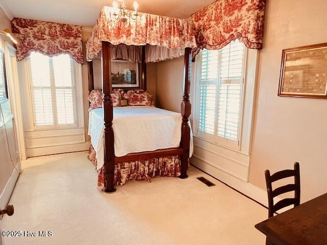 45 Hb Lewis Rd, Clinton, NC 28328 - bedroom with carpet flooring, multiple windows, and a chandelier