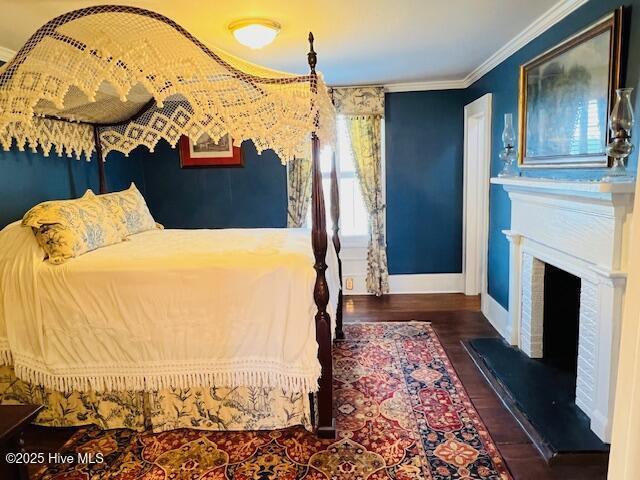 45 Hb Lewis Rd, Clinton, NC 28328 - bedroom featuring wood finished floors, baseboards, crown molding, and a fireplace