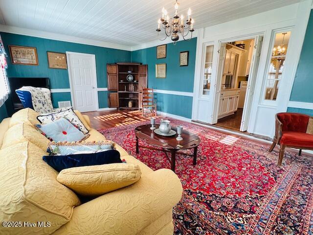 45 Hb Lewis Rd, Clinton, NC 28328 - living area with a chandelier, wood finished floors, a wainscoted wall, and ornamental molding