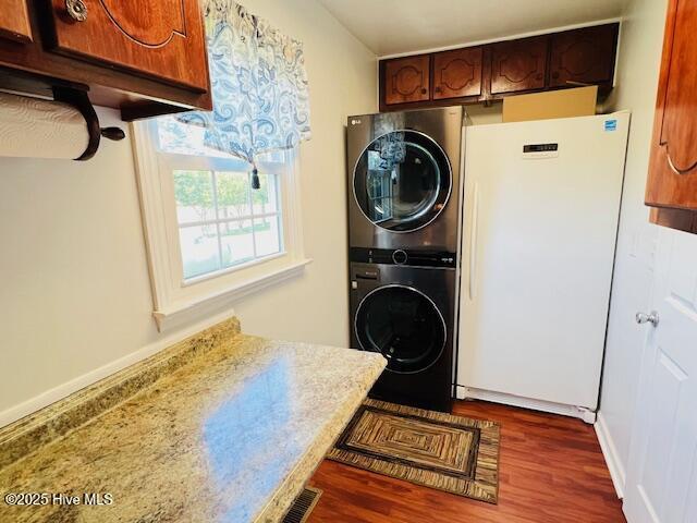 45 Hb Lewis Rd, Clinton, NC 28328 - washroom featuring stacked washer / dryer, dark wood-style floors, and baseboards