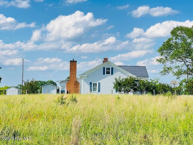 45 Hb Lewis Rd, Clinton, NC 28328 - view of side of property with a chimney, a storage unit, and an outdoor structure