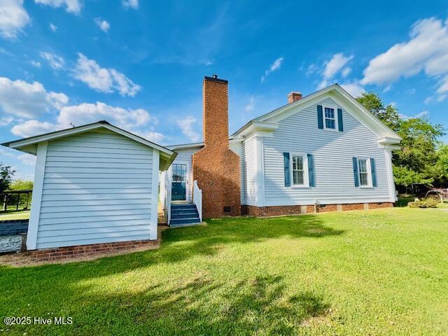 45 Hb Lewis Rd, Clinton, NC 28328 - back of property featuring a lawn and a chimney
