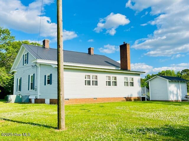 45 Hb Lewis Rd, Clinton, NC 28328 - back of property with a chimney, a storage shed, a yard, and an outbuilding