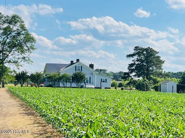 45 Hb Lewis Rd, Clinton, NC 28328 - view of side of home featuring agricultural area, a view of rural / pastoral area, a chimney, an outbuilding, and a storage unit