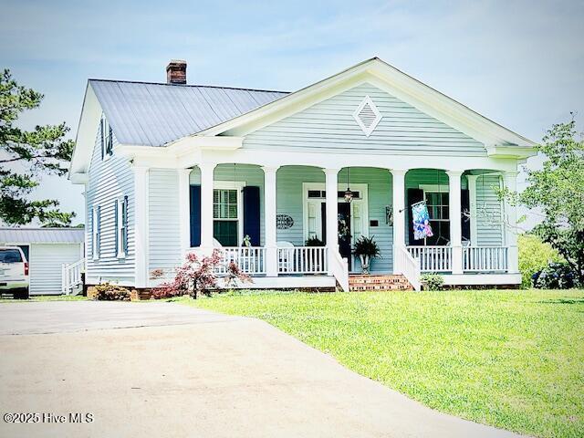 45 Hb Lewis Rd, Clinton, NC 28328 - view of front of home with a chimney, covered porch, a front lawn, and metal roof