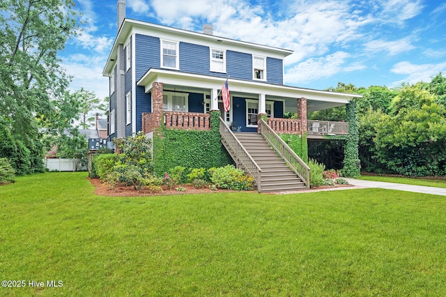 view of front of property featuring a chimney, stairway, a porch, and a front lawn