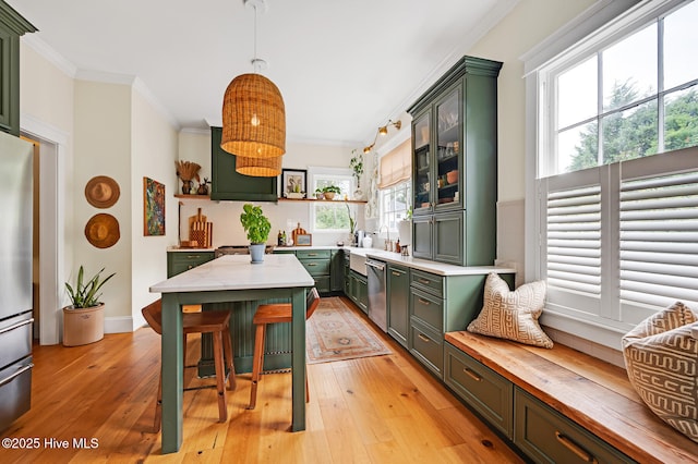 kitchen featuring green cabinetry, ornamental molding, light wood finished floors, and open shelves