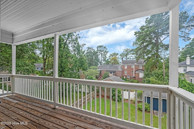 wooden deck featuring a yard and a residential view