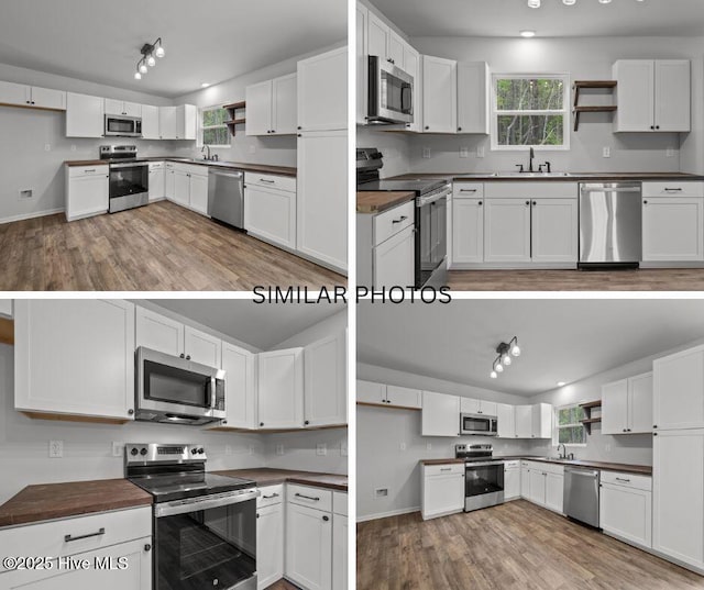 kitchen with light wood-type flooring, dark countertops, open shelves, and appliances with stainless steel finishes