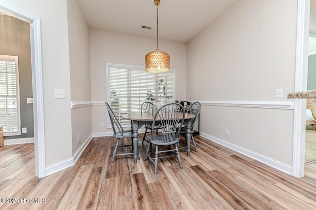 dining area featuring wood finished floors and baseboards